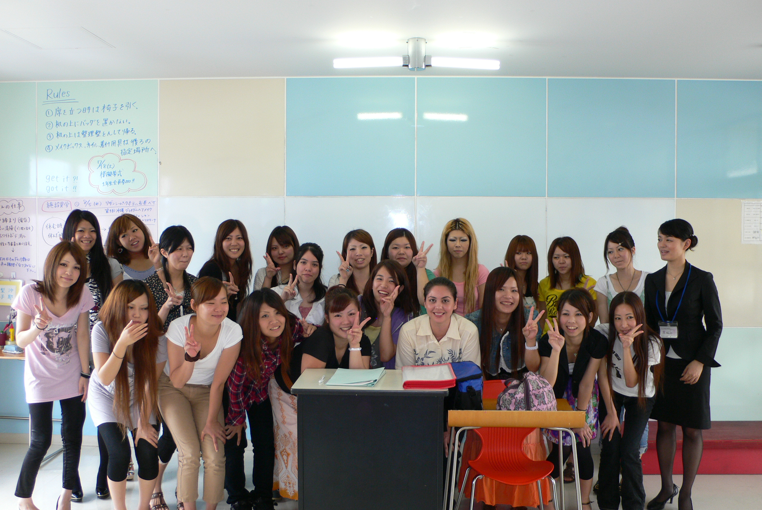 Students in front of a traditional Okinawan building